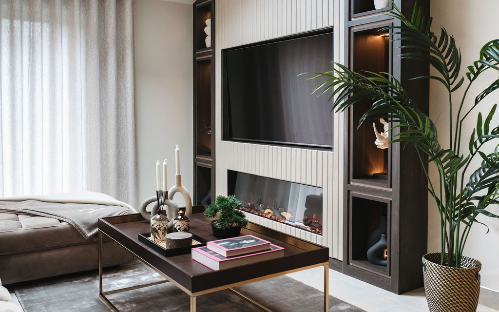 interior design case study shows a large fire and tv feature wall