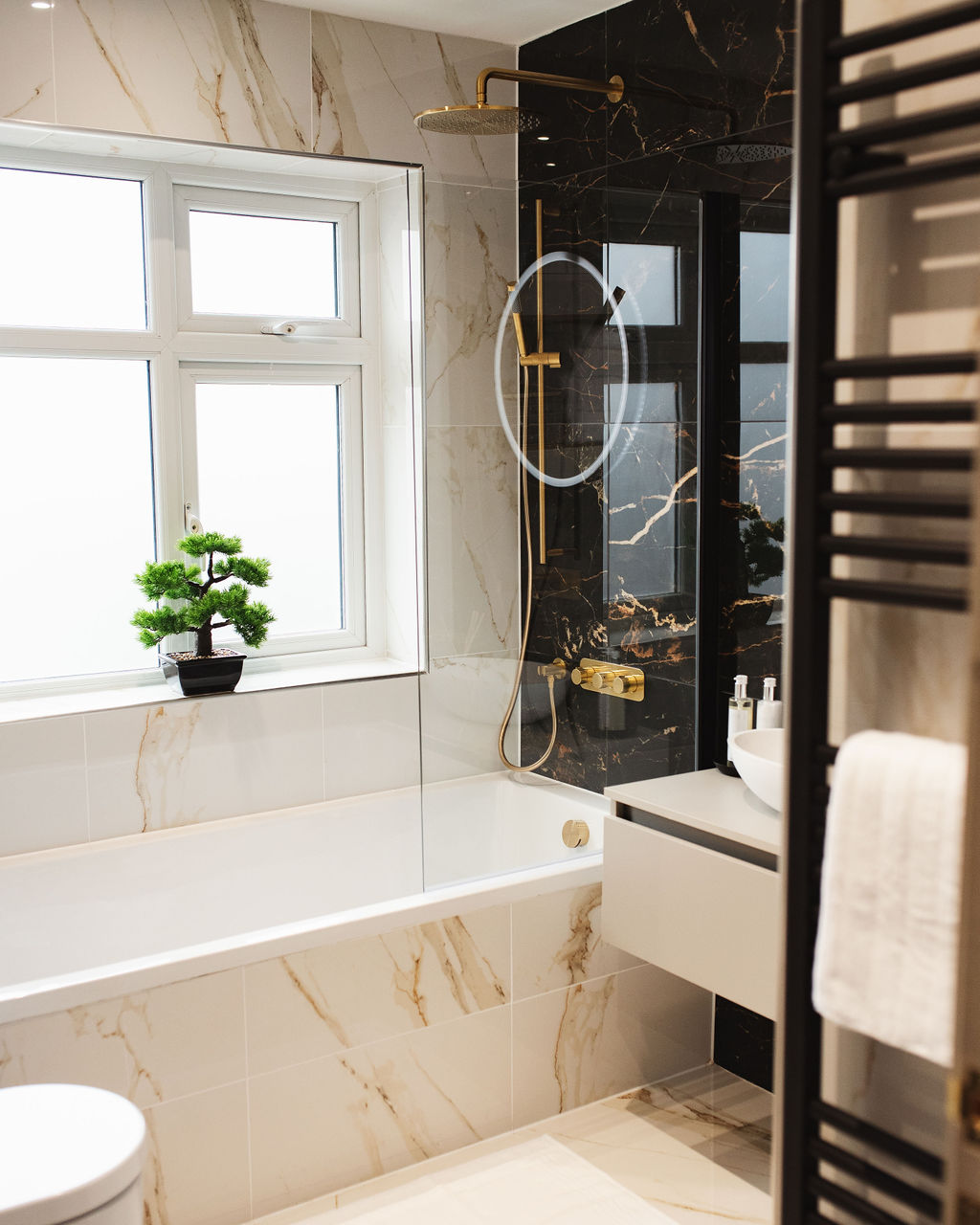 interior design case study image of a cream and black marble bathroom