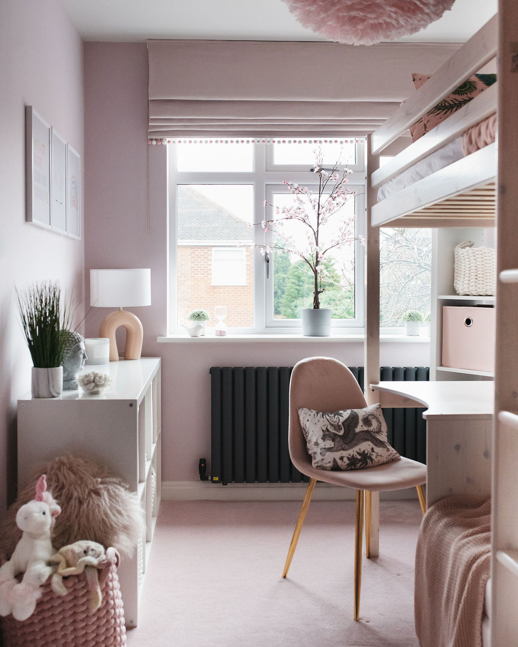 interior of a girls bedroom with pale pink walls and a bunk bed