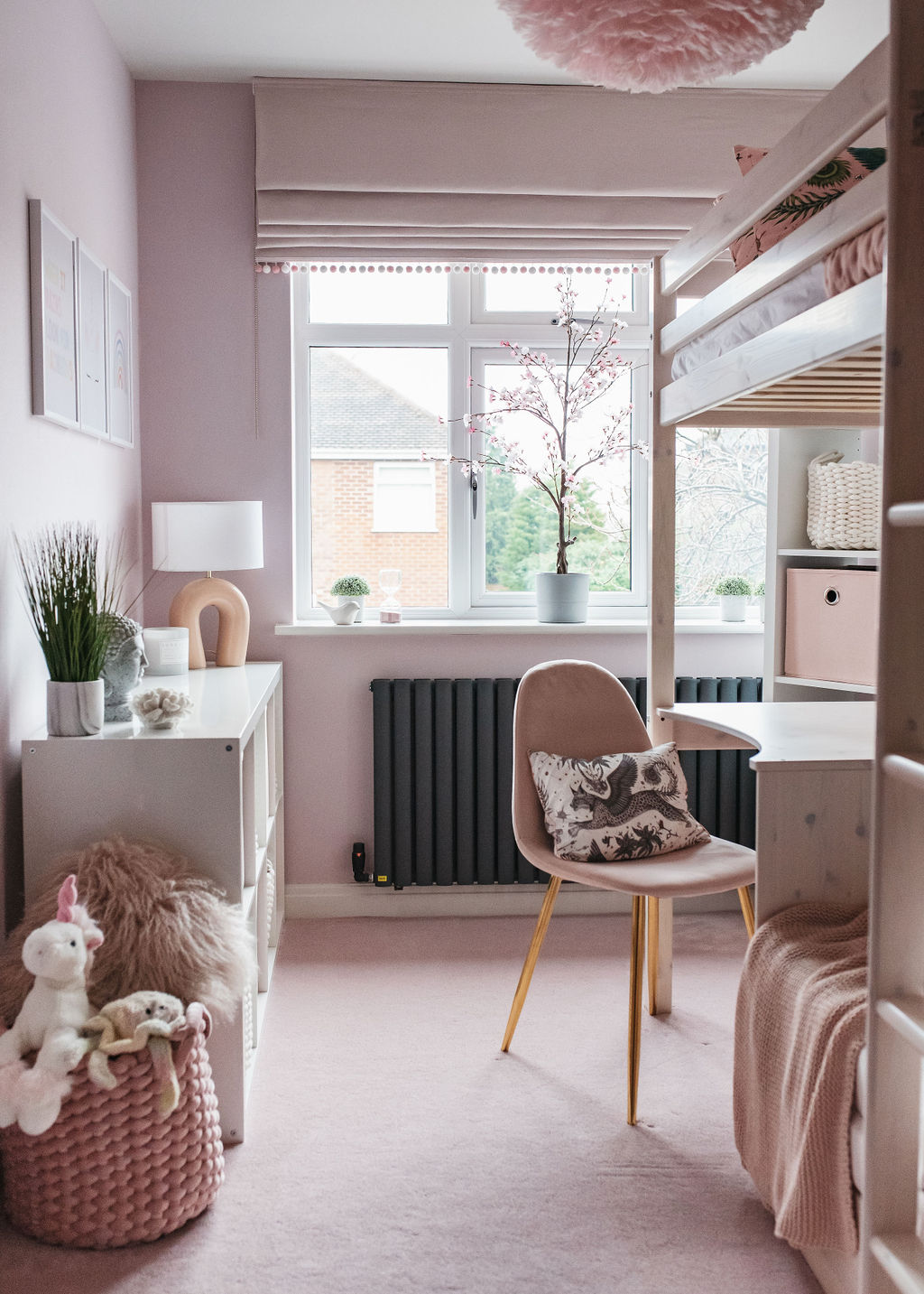 interior of a girls bedroom with pink walls and carpet