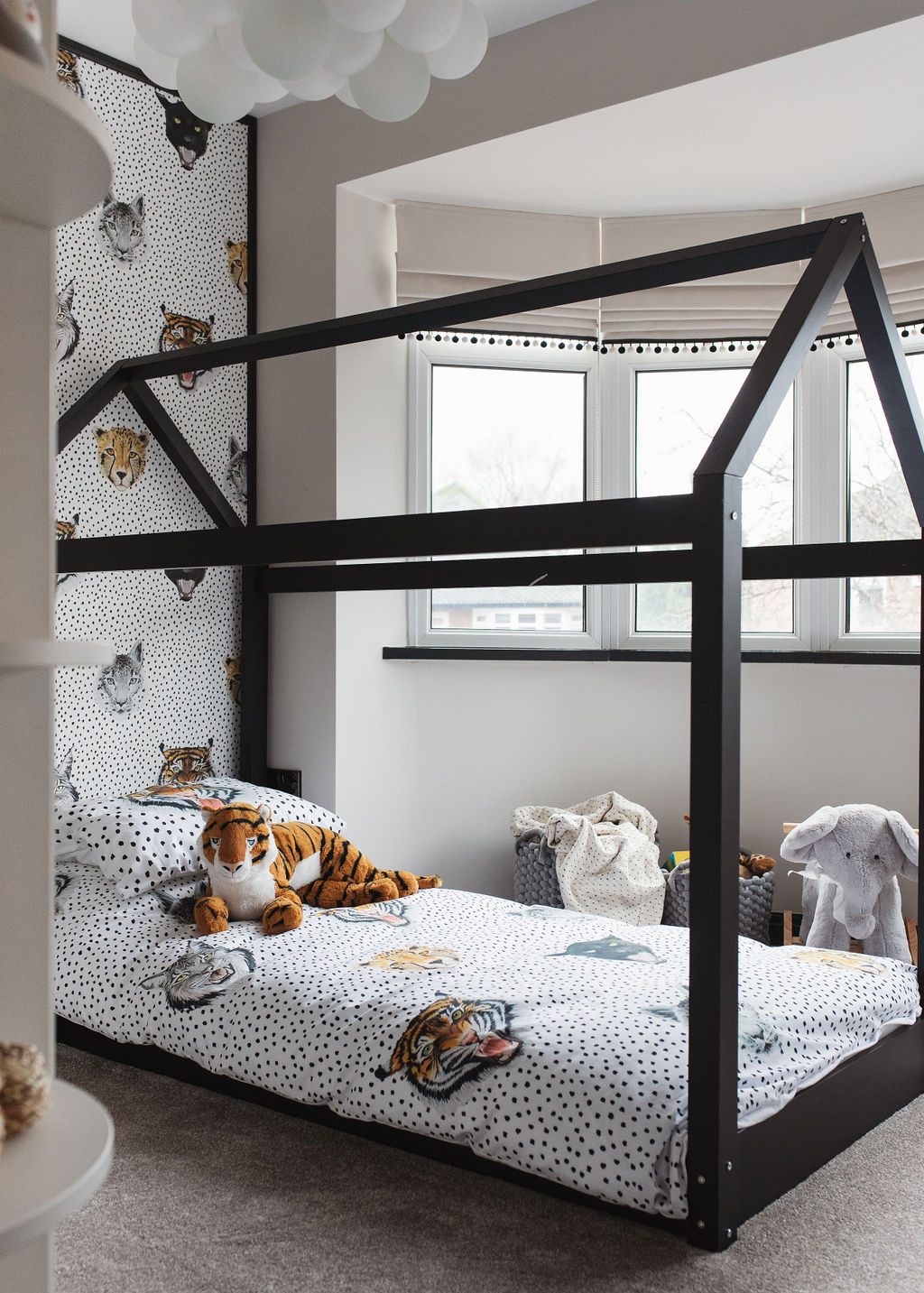 a childs bedroom designed by Melissa with a black bed and tiger wallapaper